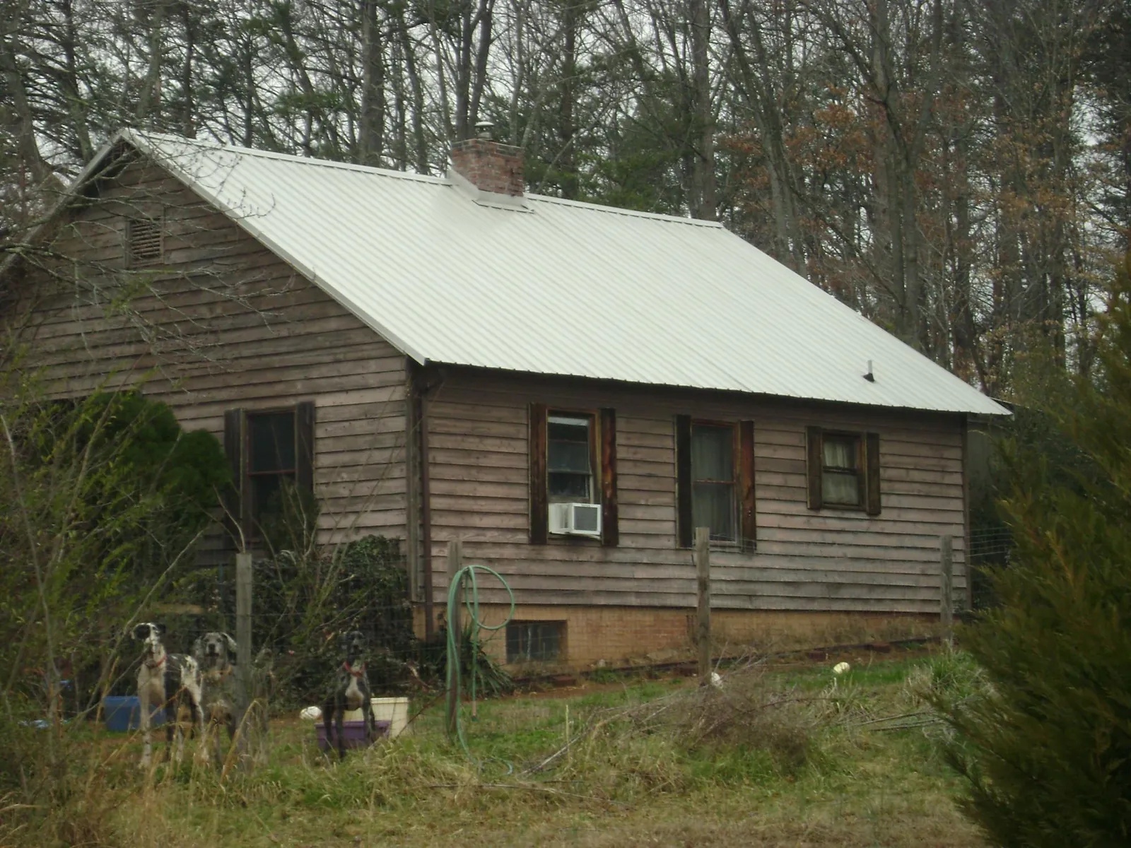 White metal roof on an old wood sided farmhouse, from a Metal Roof Installation job in Perry